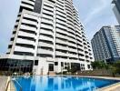 Modern high-rise residential building with outdoor swimming pool