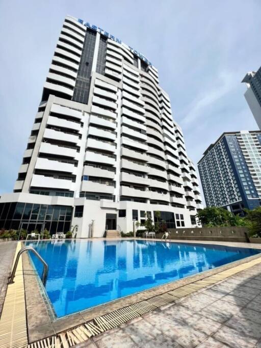 Modern high-rise residential building with outdoor swimming pool