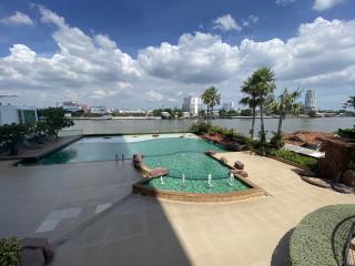 Luxurious infinity pool overlooking the river with city skyline in the background