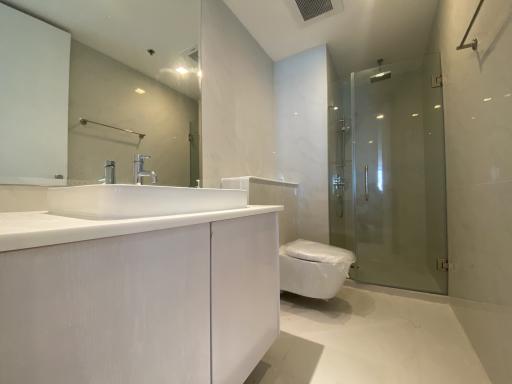 Modern bathroom with glass shower and white vanity