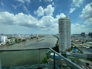 Panoramic view from the balcony showcasing the river, city skyline, and surrounding buildings