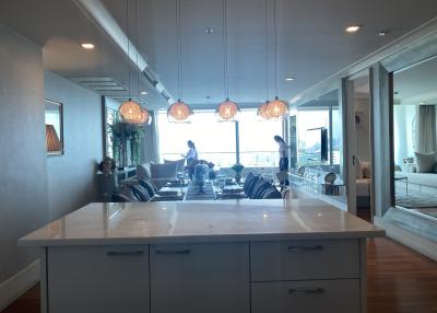 Modern kitchen with island and open plan layout leading to living room