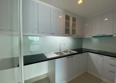 Modern kitchen with white cabinetry and black countertops