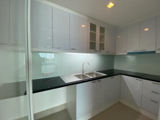 Modern kitchen with white cabinetry and black countertops