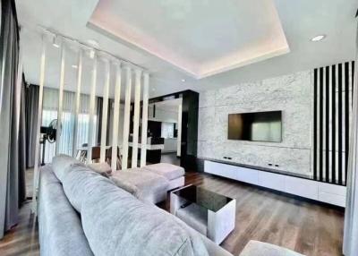 Modern living room with recessed lighting and contemporary decor
