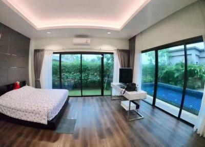 Spacious Bedroom with Pool View and Modern Amenities