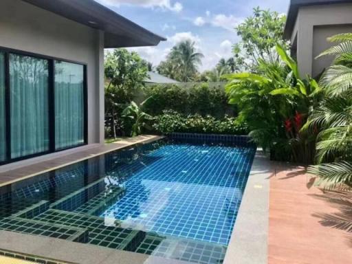 Spacious outdoor area with a private swimming pool and lush greenery