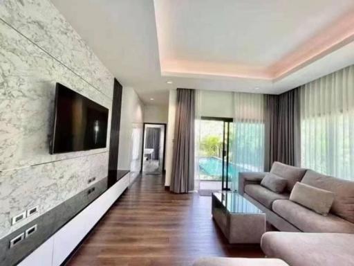 Modern living room interior with marble wall, flat screen TV, and comfortable sofa