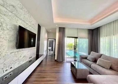 Modern living room interior with marble wall, flat screen TV, and comfortable sofa