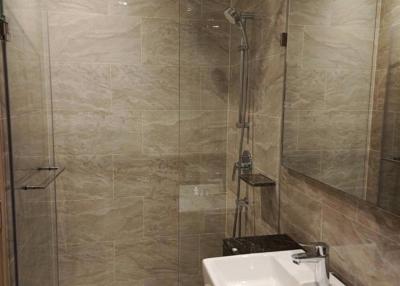 Modern bathroom with walk-in shower and neutral tiles