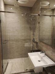 Modern bathroom with walk-in shower and neutral tiles