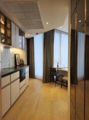 Modern kitchen with adjacent dining area and large window providing natural light