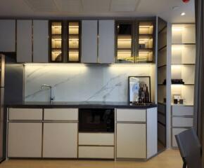 Modern kitchen with marble backsplash and built-in appliances