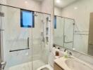 Modern bathroom interior with glass shower and mirror