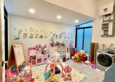 Spacious playroom with toys and modern appliances