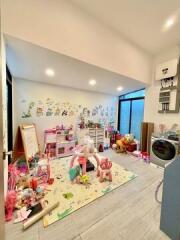 Spacious playroom with toys and modern appliances