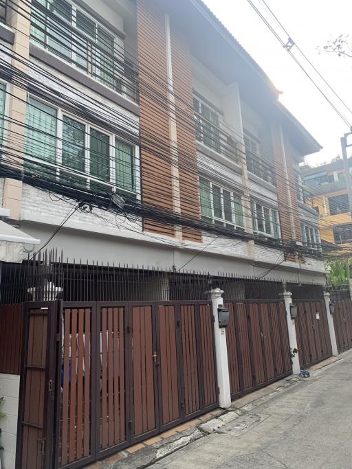 Modern multi-story residential building with wooden facade elements