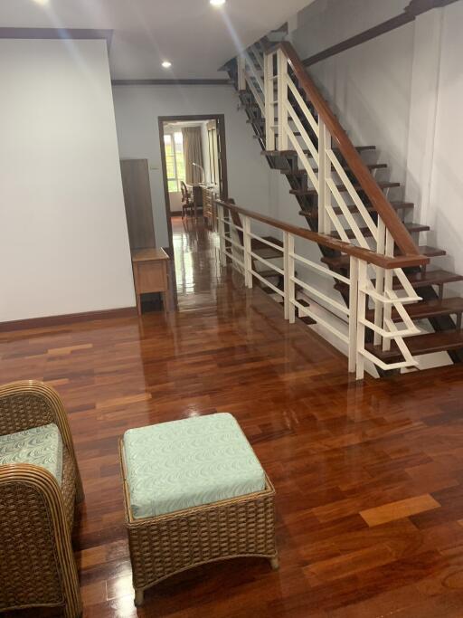 Cozy interior foyer with staircase and wooden flooring