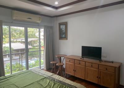 Spacious bedroom with large windows and modern amenities