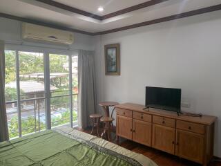 Spacious bedroom with large windows and modern amenities