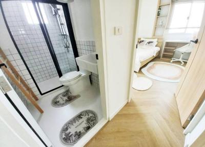 Bright modern bathroom with walk-in shower and black framed glass door