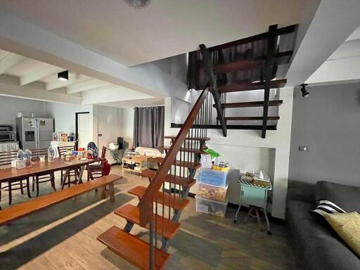 Spacious living room with dining area and open staircase