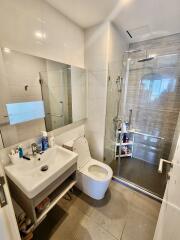 Modern bathroom with walk-in shower and white ceramic fixtures