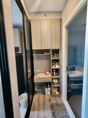 Compact laundry room with built-in cabinets and wood flooring