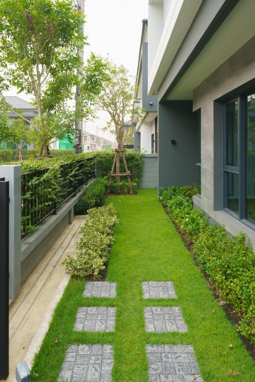 Well-manicured garden with a walking path by the house