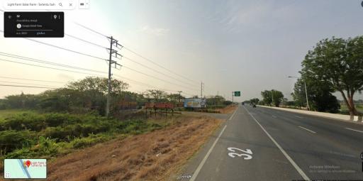Wide road with clear sky and surrounding greenery
