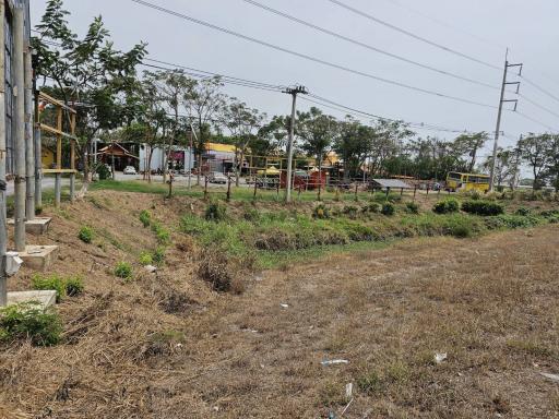 Outdoor area near a property with vegetation and power lines