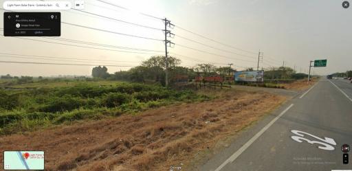 Open land beside a highway with power lines