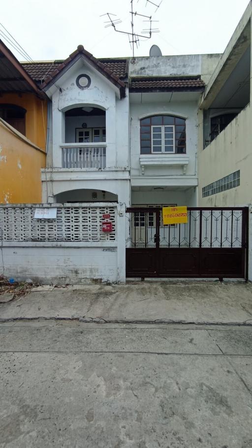 Two-story residential home with a gated entrance