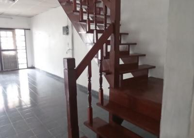 Wooden staircase in a home interior with tile flooring