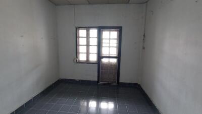 Empty interior room with tiled floor and window