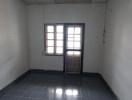 Empty interior room with tiled floor and window