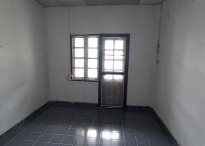 Empty interior room with tiled floor and window