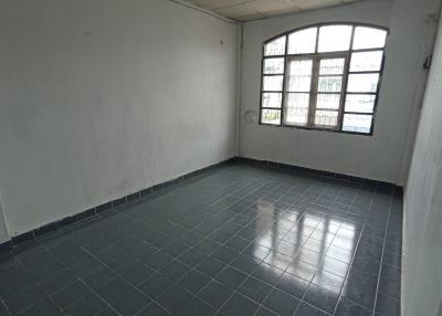 Empty room with tiled flooring and large window