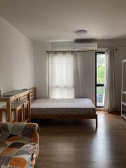 Cozy bedroom with a large bed and natural light