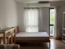 Cozy bedroom with a large bed and natural light