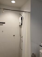 Well-maintained bathroom with white tile walls and modern shower