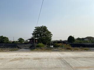 Outdoor view of a vacant land with concrete surface and surrounding buildings
