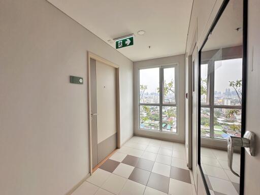 Bright corridor with large windows and city view