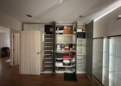 Well-organized storage room with shelving units and wooden flooring