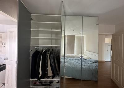 Spacious bedroom with mirrored wardrobe and minimalistic design