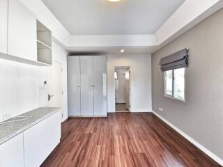 Modern kitchen with hardwood floors and ample natural light