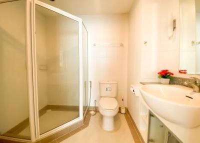 Modern bathroom with shower cubicle and white fixtures