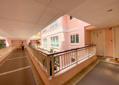 Corridor of a residential building with a person in the distance