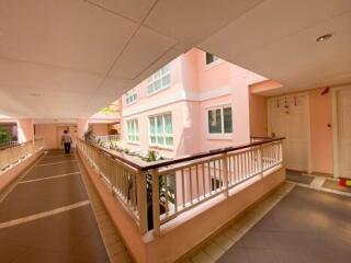 Corridor of a residential building with a person in the distance