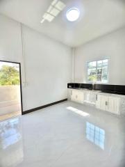 Modern kitchen with white cabinets and natural light